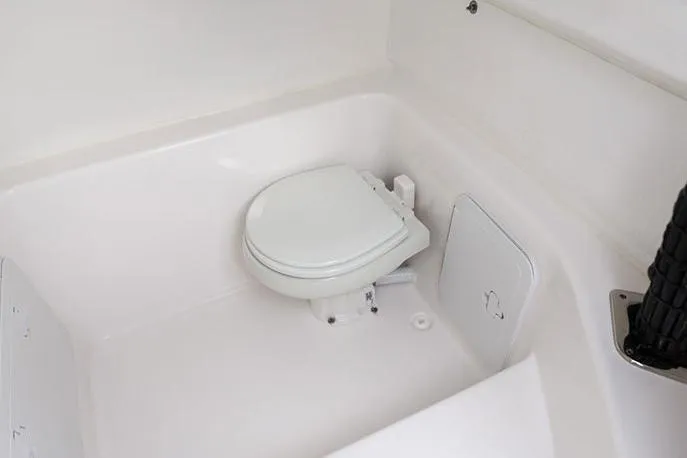Slide: The Image of Manufacturer Provided Image: 2026 Cape Horn 31 T boat interior with a compact white marine toilet. - 19