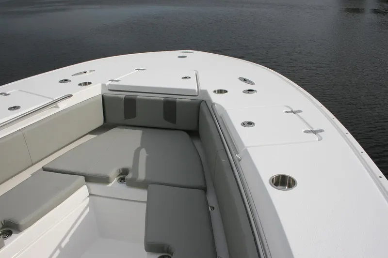 Slide: The Image of Manufacturer Provided Image: 2026 Cape Horn 34 XS boat interior with cushioned seating and cup holders on calm water. - 2
