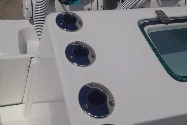 Slide: The Image of Manufacturer Provided Image: 2026 Cape Horn 34 XS boat deck with rod holders and storage compartment. - 8