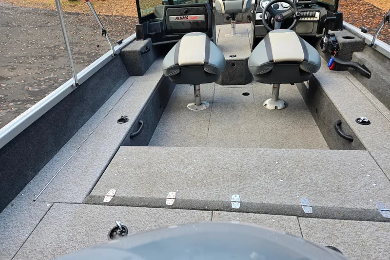 Slide: The Image of 2020 Alumacraft Voyageur 175 Sport interior with dual seats and steering console. - 10
