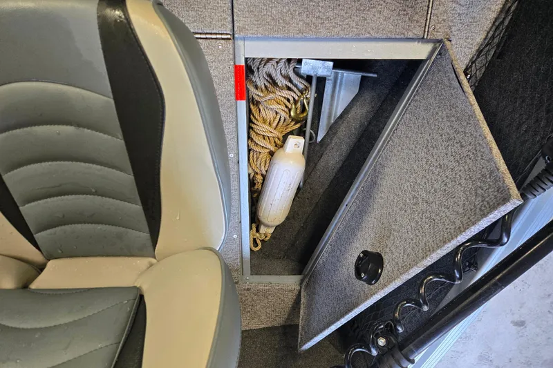 Slide: The Image of 2020 Alumacraft Voyageur 175 Sport boat storage compartment with rope and anchor. - 15