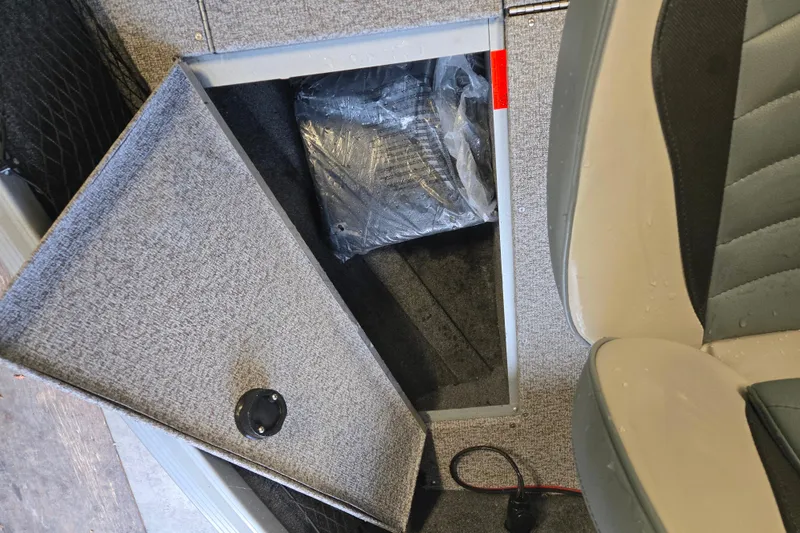 Slide: The Image of 2020 Alumacraft Voyageur 175 Sport storage compartment with open hatch and seat view. - 16