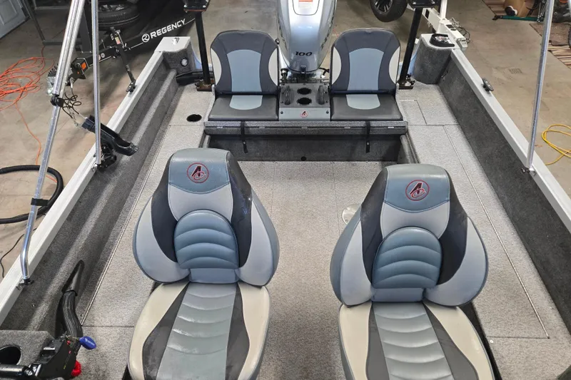 Slide: The Image of 2020 Alumacraft Voyageur 175 Sport boat interior with seating and motor. - 17