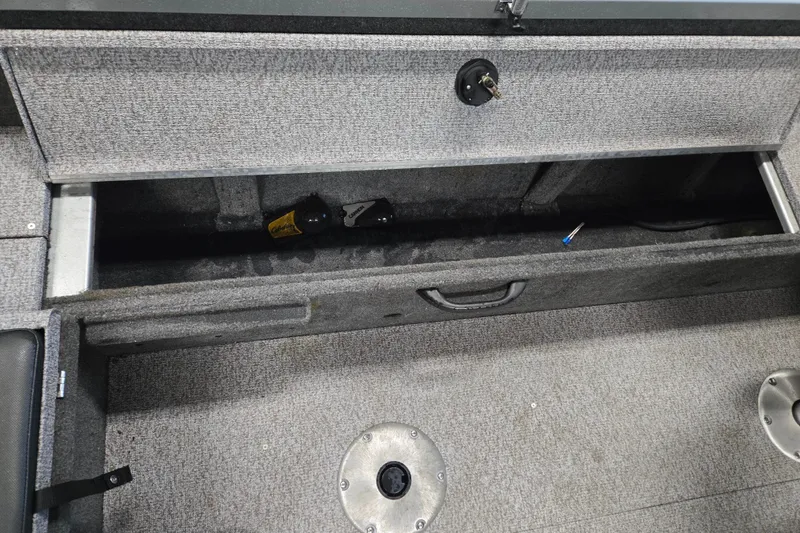 Slide: The Image of 2020 Alumacraft Voyageur 175 Sport storage compartment with carpeted interior and lockable latch. - 20