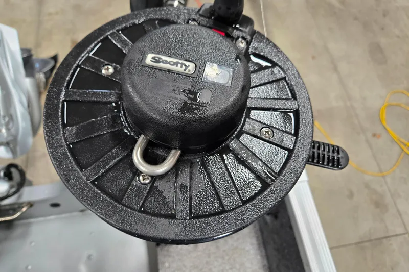 Slide: The Image of Close-up of a Scotty fishing reel on a 2020 Alumacraft Voyageur 175 Sport boat. - 21