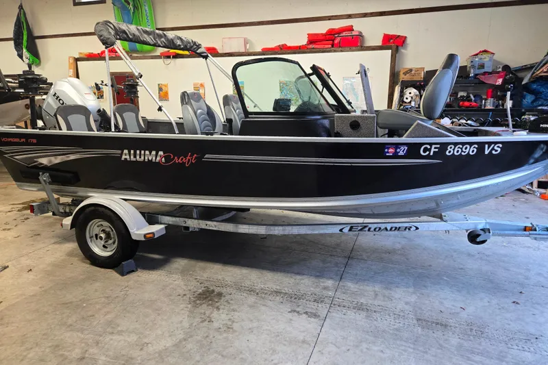 Slide: The Image of 2020 Alumacraft Voyageur 175 Sport boat on trailer in garage setting. - 22