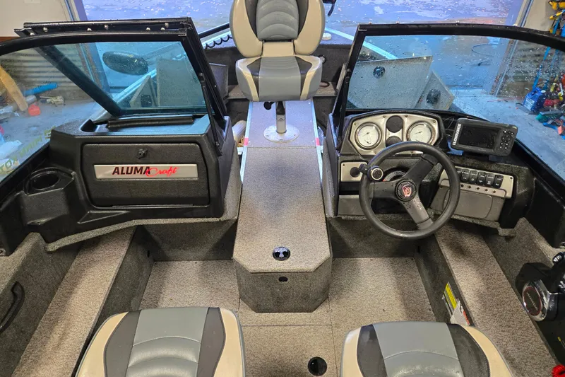 Slide: The Image of 2020 Alumacraft Voyageur 175 Sport boat interior with steering wheel and dashboard. - 3