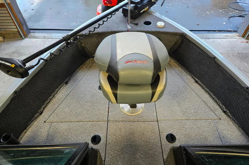 Slide: The Image of 2020 Alumacraft Voyageur 175 Sport boat interior with seating and trolling motor. - 6