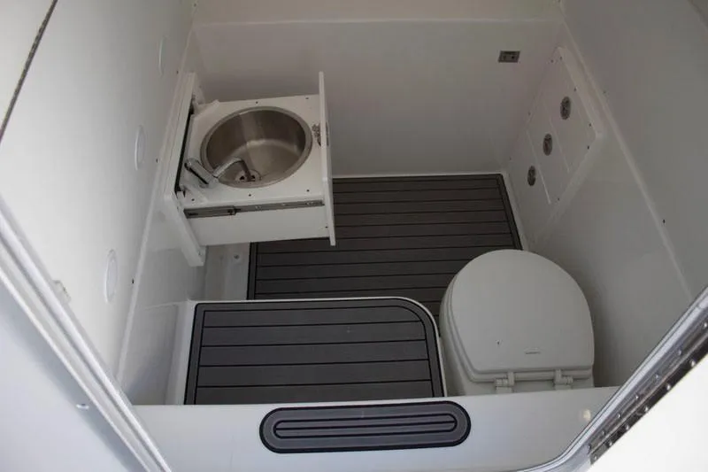 Slide: The Image of Manufacturer Provided Image: 2026 Cape Horn 36 XS boat bathroom with sink and toilet, featuring sleek design and modern fixtures. - 11