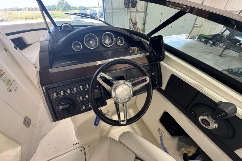 Slide: The Image of Interior view of 2015 Sea Ray 250 SLX boat dashboard with steering wheel and controls. - 10