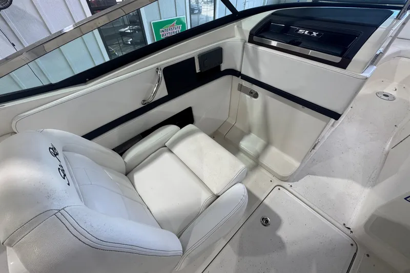 Slide: The Image of Interior of a 2015 Sea Ray 250 SLX boat with white seating and dashboard. - 11