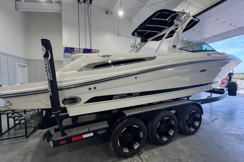 Slide: The Image of 2015 Sea Ray 250 SLX boat on a trailer in a garage setting. - 4
