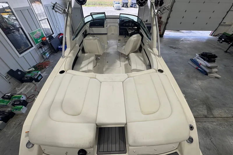 Slide: The Image of 2015 Sea Ray 250 SLX boat interior with white seating in a garage setting. - 7