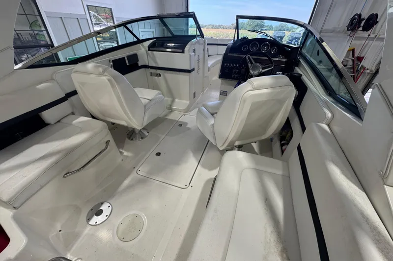 Slide: The Image of Interior of a 2015 Sea Ray 250 SLX boat with white seating and steering console. - 8