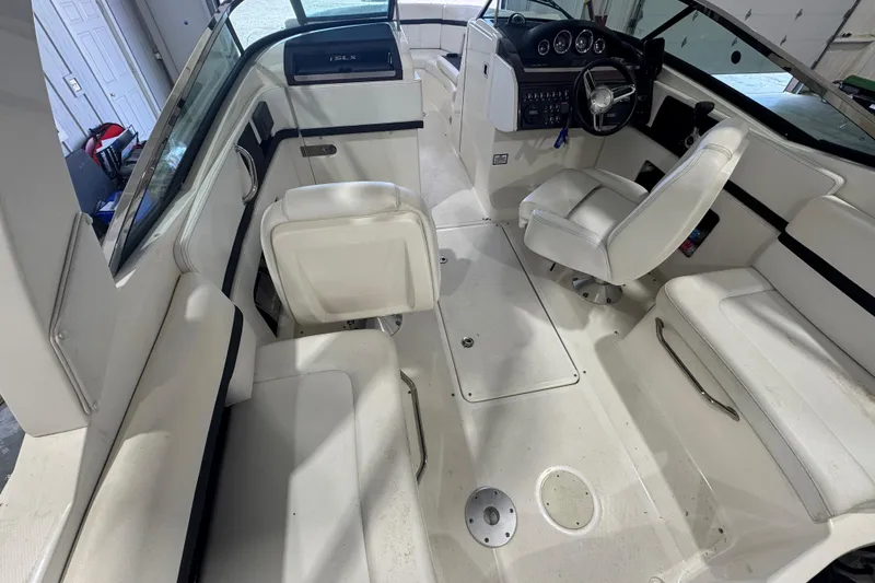 Slide: The Image of Interior of a 2015 Sea Ray 250 SLX boat with white seating and steering console. - 9