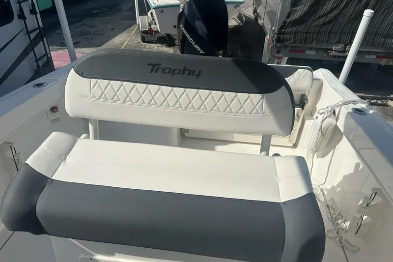 Slide: The Image of 2024 Bayliner Trophy T24CC boat seating with "Trophy" logo, featuring white and gray upholstery. - 10