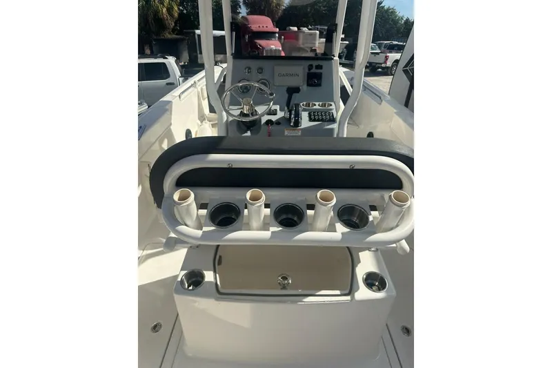 Slide: The Image of 2024 Bayliner Trophy T24CC boat console with steering wheel and rod holders. - 11
