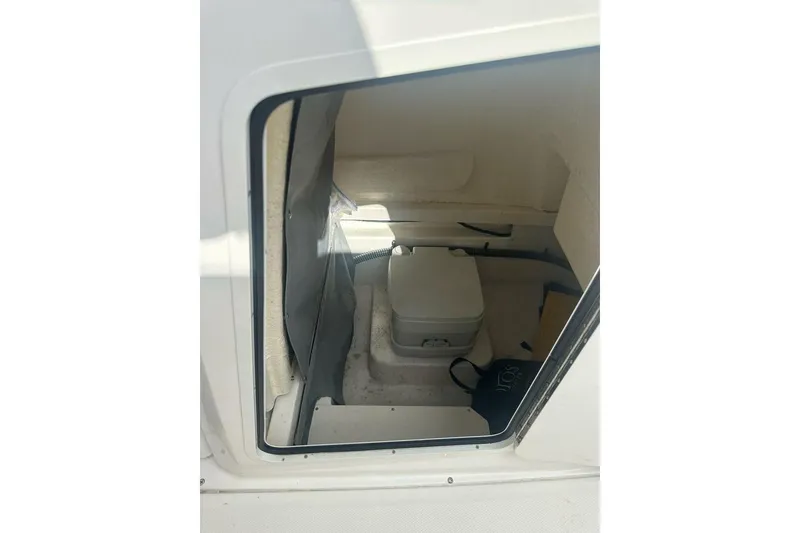 Slide: The Image of 2024 Bayliner Trophy T24CC boat interior with compact toilet compartment. - 17