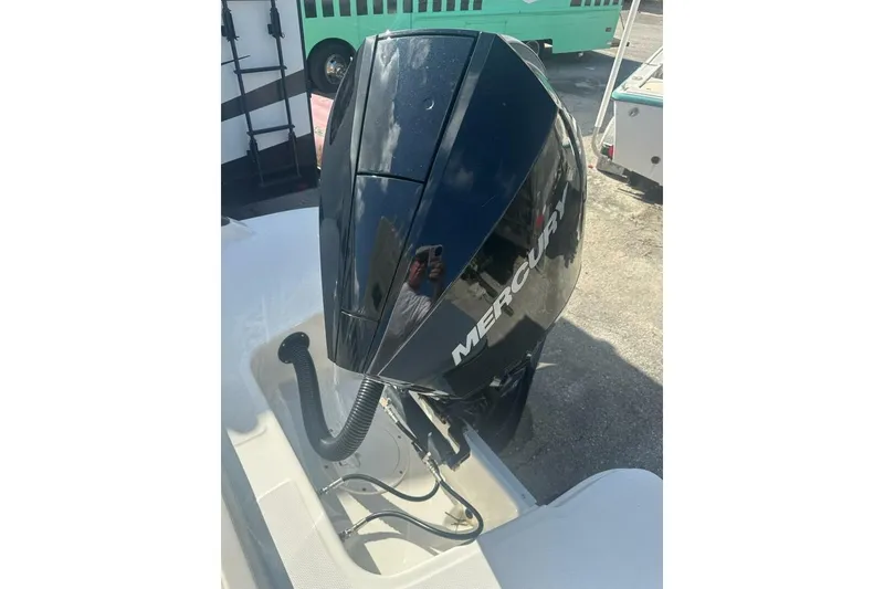 Slide: The Image of 2024 Bayliner Trophy T24CC with Mercury outboard engine, parked outdoors. - 18