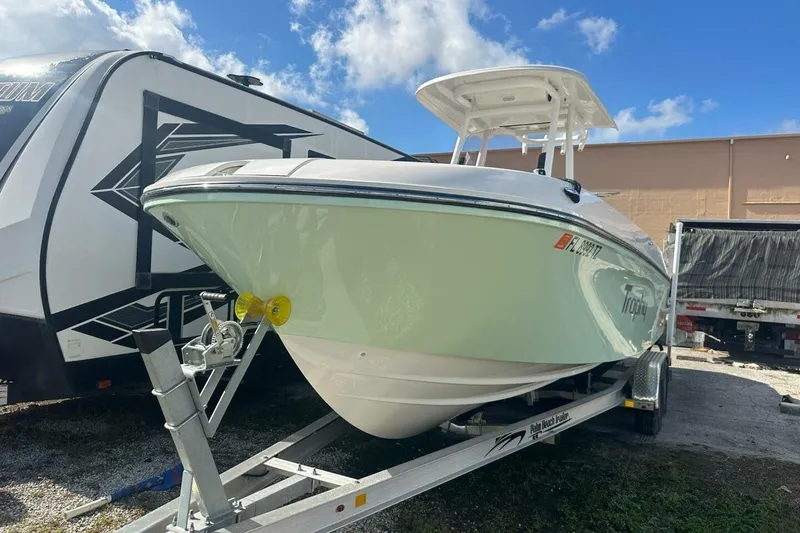 Slide: The Image of 2024 Bayliner Trophy T24CC boat on trailer under blue sky. - 26