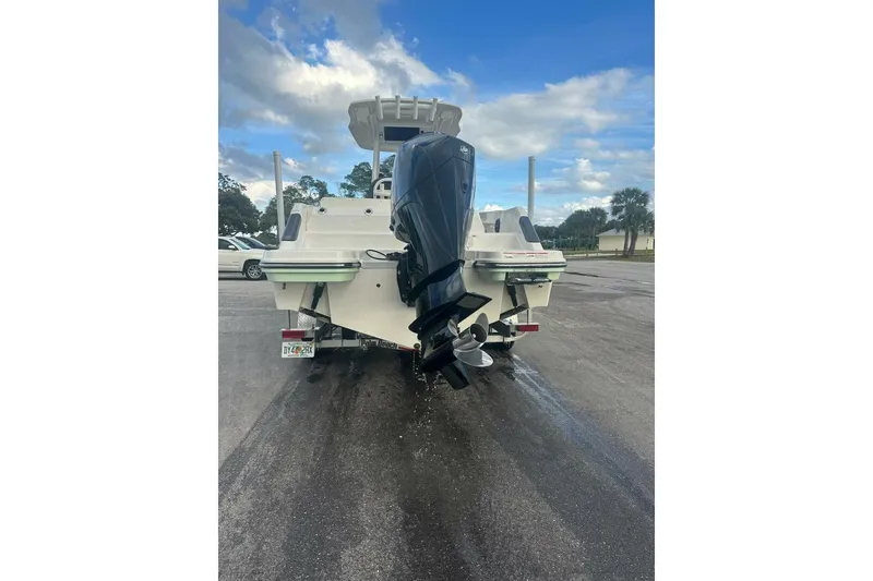 Slide: The Image of 2024 Bayliner Trophy T24CC boat rear view with outboard motor on trailer. - 27