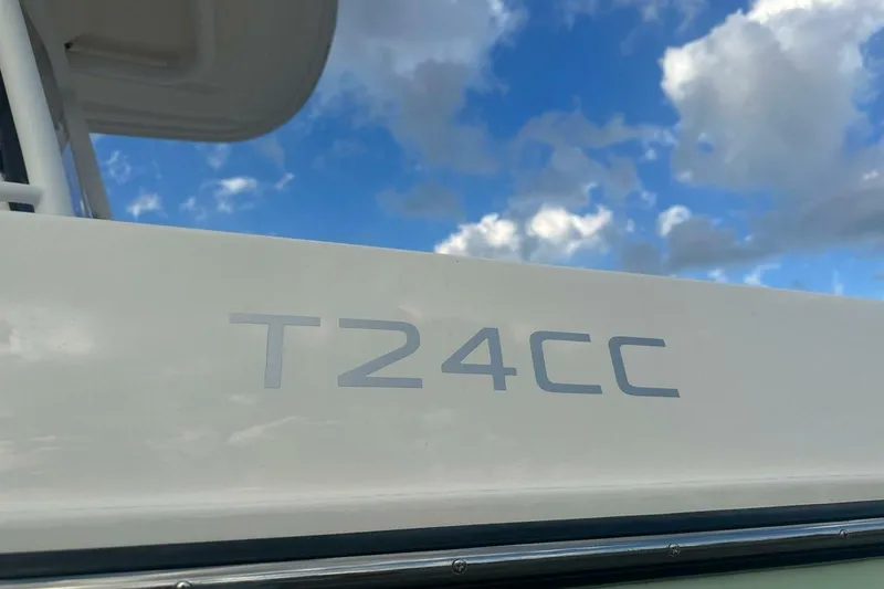 Slide: The Image of 2024 Bayliner Trophy T24CC boat against a cloudy blue sky. - 28