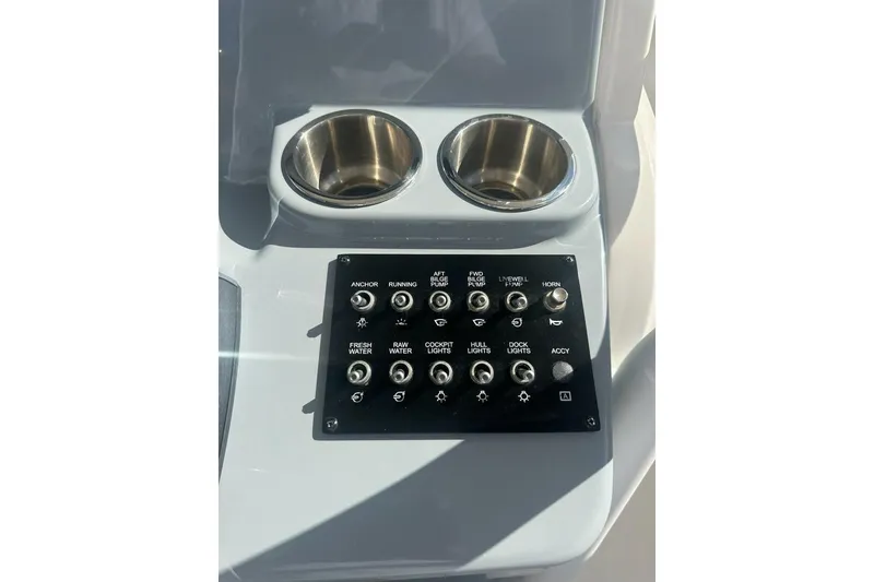 Slide: The Image of Control panel and cup holders on 2024 Bayliner Trophy T24CC boat. - 6