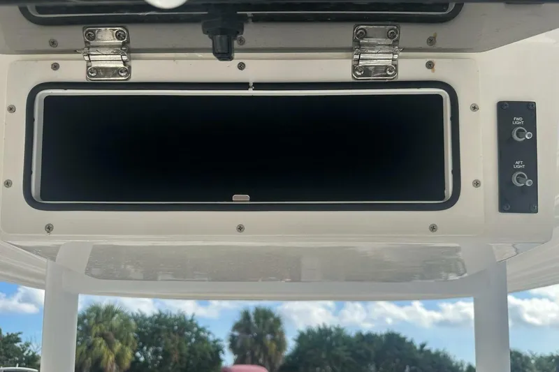 Slide: The Image of 2024 Bayliner Trophy T24CC boat console with storage compartment and light controls. - 9