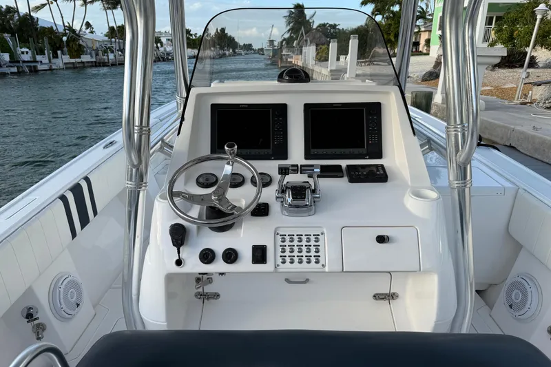 Slide: The Image of Cockpit of 2013 Intrepid 327 Cuddy boat with steering wheel and navigation screens. - 4
