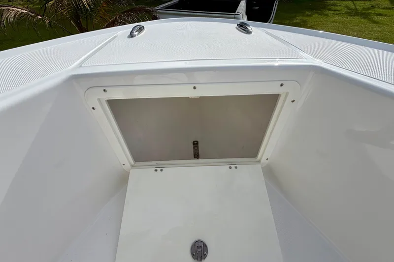 Slide: The Image of 2025 Ocean Master 296 Center Console boat storage compartment, open and empty. - 15