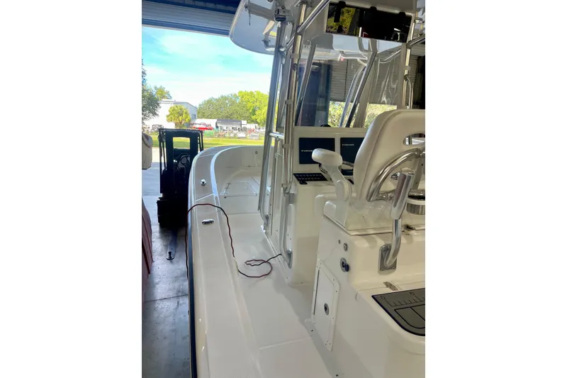 Slide: The Image of 2025 Ocean Master 296 Center Console boat in a garage setting. - 27