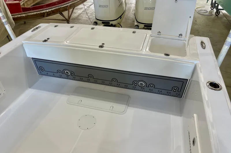 Slide: The Image of 2025 Ocean Master 296 Center Console boat interior with storage compartments and measurement panel. - 28