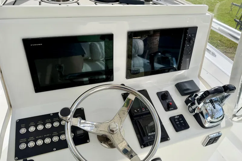 Slide: The Image of 2025 Ocean Master 296 Center Console helm with dual screens and modern controls. - 5