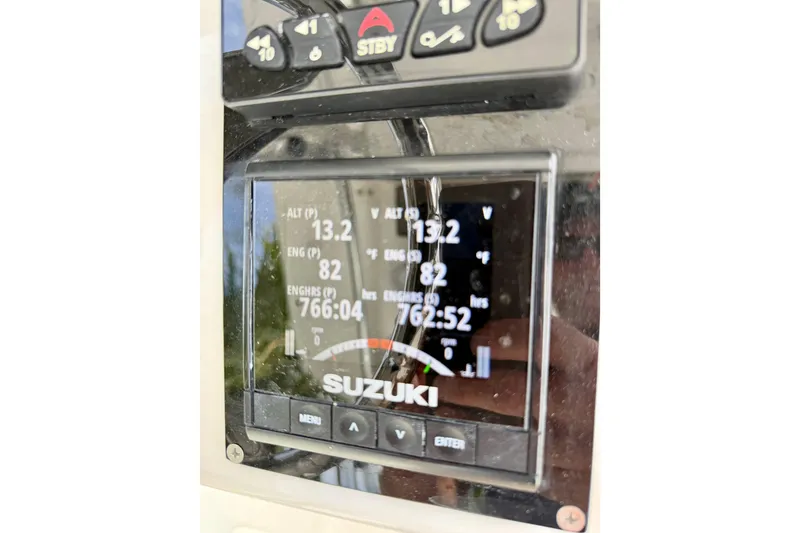 Slide: The Image of Close-up of Suzuki engine display on 2025 Ocean Master 296 Center Console boat. - 19