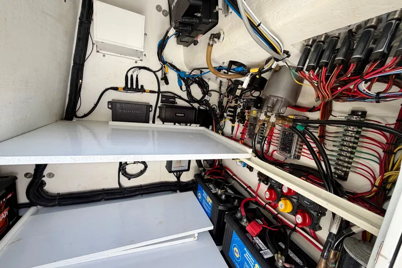 Slide: The Image of Electrical wiring and components inside a 2025 Ocean Master 296 Center Console boat. - 22