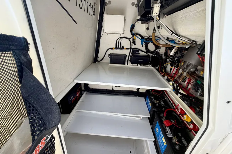 Slide: The Image of Interior view of 2025 Ocean Master 296 Center Console's electrical compartment. - 23