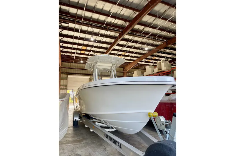 Slide: The Image of 2025 Ocean Master 296 Center Console boat in a warehouse on a trailer. - 24