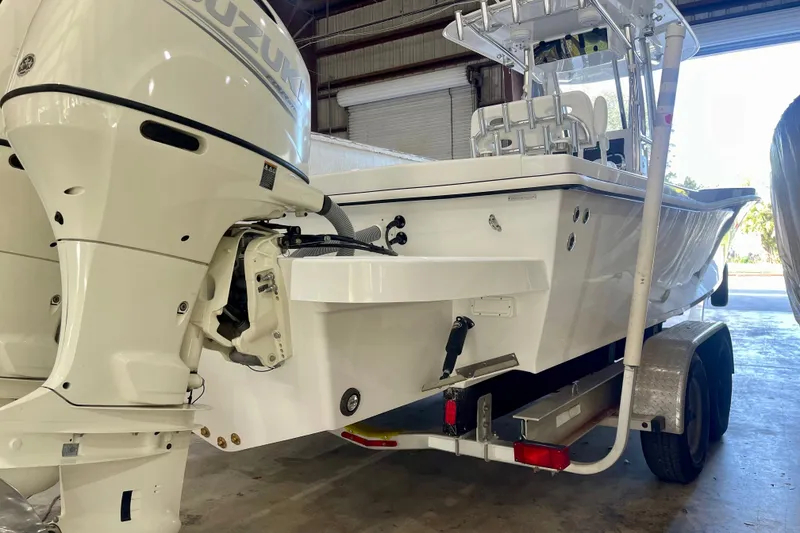 Slide: The Image of 2025 Ocean Master 296 Center Console boat with Suzuki outboard engines in a garage. - 25
