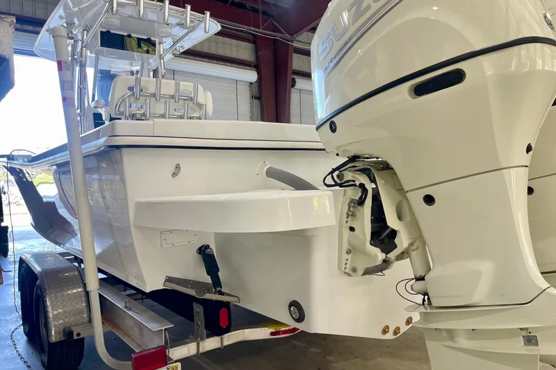 Slide: The Image of 2025 Ocean Master 296 Center Console boat with Suzuki outboard motor in a garage. - 26