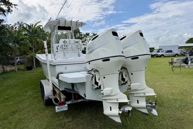 Slide: The Image of 2025 Ocean Master 296 Center Console boat with twin Suzuki outboard engines on a trailer. - 3