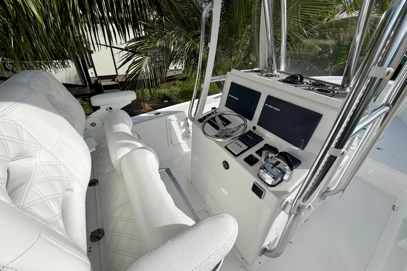 Slide: The Image of 2025 Ocean Master 296 Center Console boat interior with modern controls and white seating. - 4