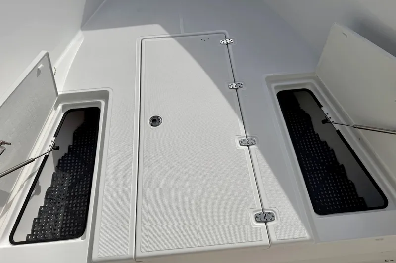Slide: The Image of 2025 Ocean Master 296 Center Console boat deck with storage compartments open. - 6