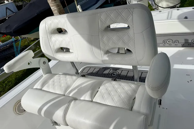 Slide: The Image of Luxury seating on 2025 Ocean Master 296 Center Console boat, featuring white quilted upholstery. - 8