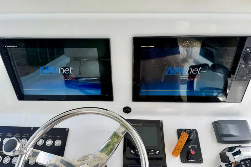 Slide: The Image of Dashboard of 2025 Ocean Master 296 Center Console with dual NAVnet touch screens. - 9