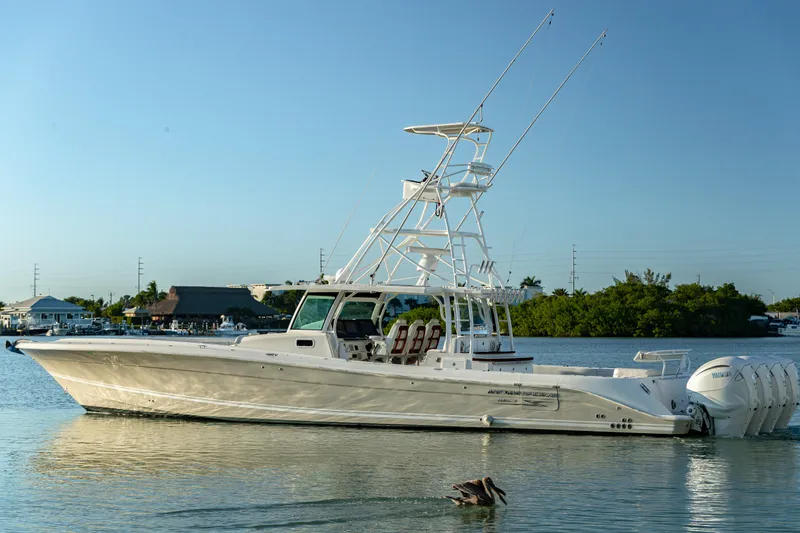 Slide: The Image of 2018 HCB 53 Suenos RXV boat on calm water with clear sky background. - 10