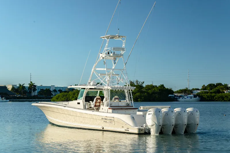 Slide: The Image of 2018 HCB 53 Suenos RXV boat with multiple outboard engines on calm water. - 13