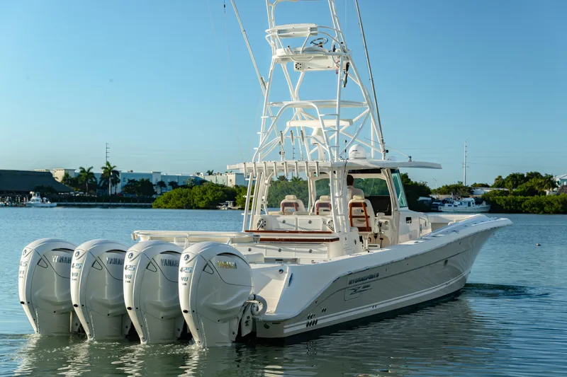 Slide: The Image of 2018 HCB 53 Suenos RXV boat with four Yamaha engines on calm water. - 16