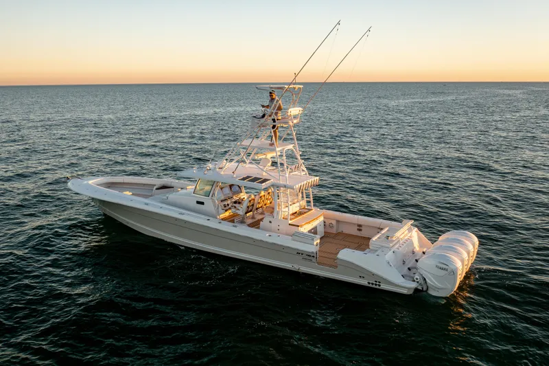 Slide: The Image of 2018 HCB 53 Suenos RXV boat on open water at sunset. - 2
