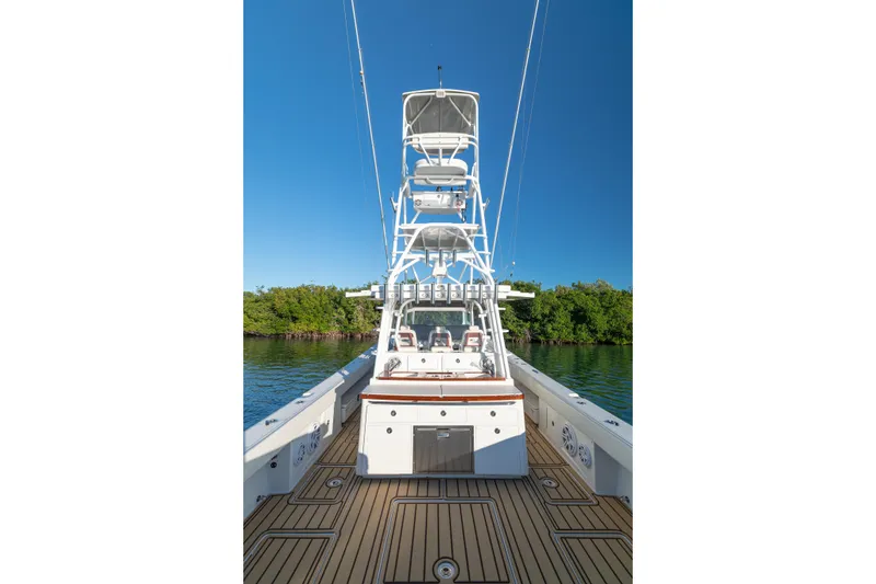 Slide: The Image of 2018 HCB 53 Suenos RXV boat with tower, docked on calm water. - 22