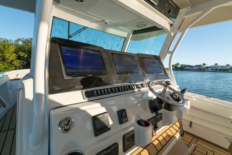 Slide: The Image of 2018 HCB 53 Suenos RXV boat helm with advanced navigation screens and steering wheel. - 25